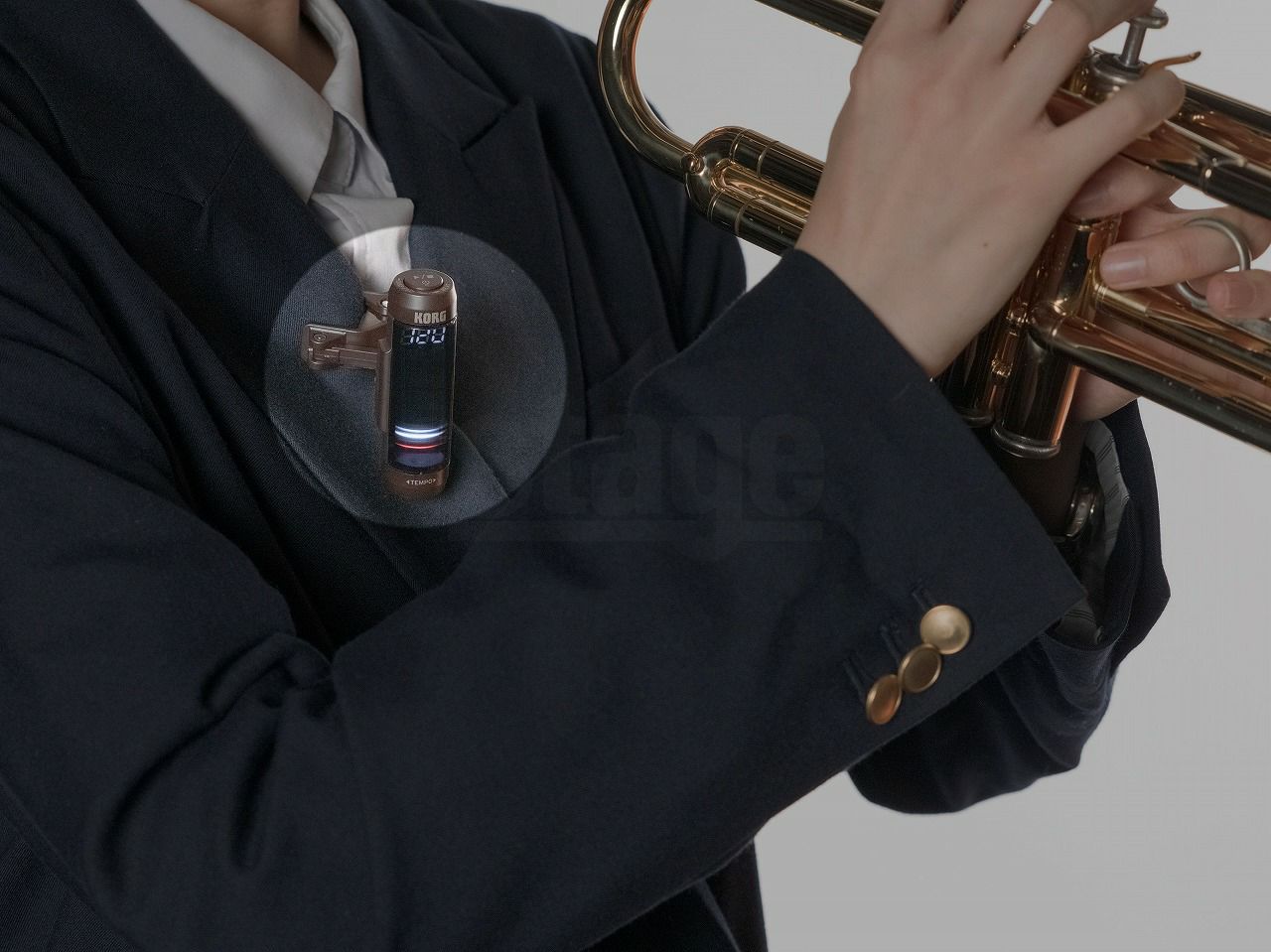 KORG MTC-1をジャケットの襟にはさんでトランペットの練習をしている
